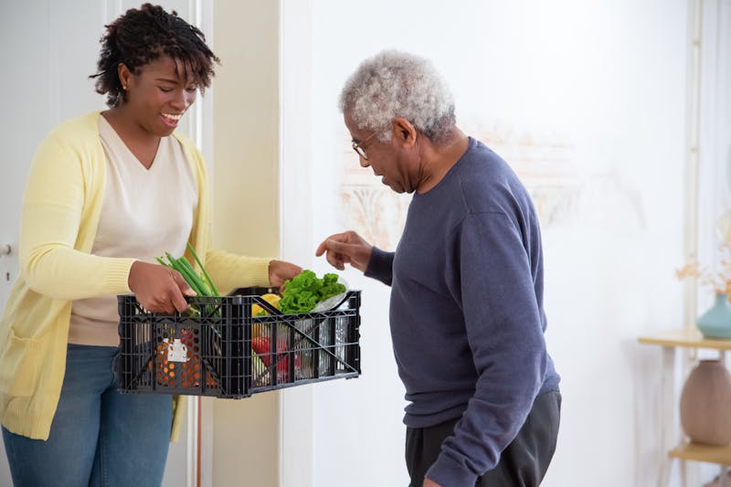 Companion caregiver smiling with elderly woman